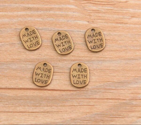 60111410 Decoración óvalo metal "Made with love" 8 x 11 mm - color bronce